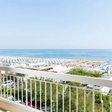Balcone con vista su una spiaggia affollata.