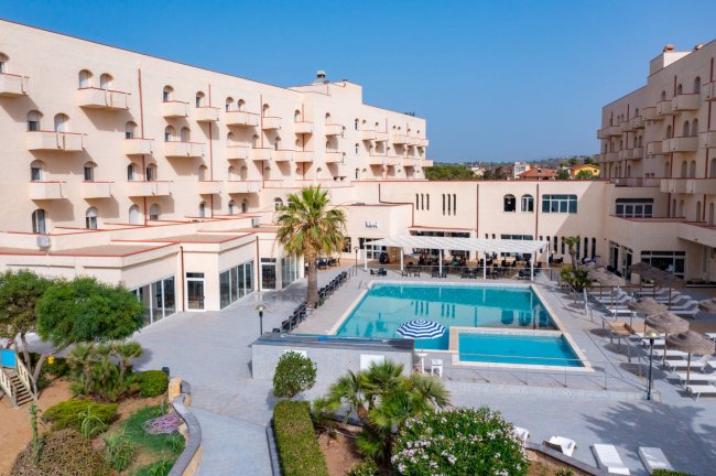 Hotel con piscina al centro.