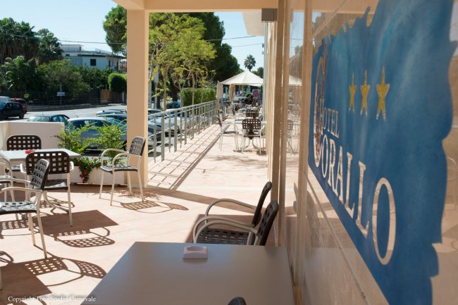 Terrazza con tavoli e sedie all'aperto.