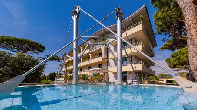 Piscina con struttura moderna e palazzi.