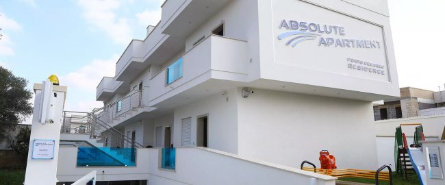 Edificio bianco con appartamenti e balconi.