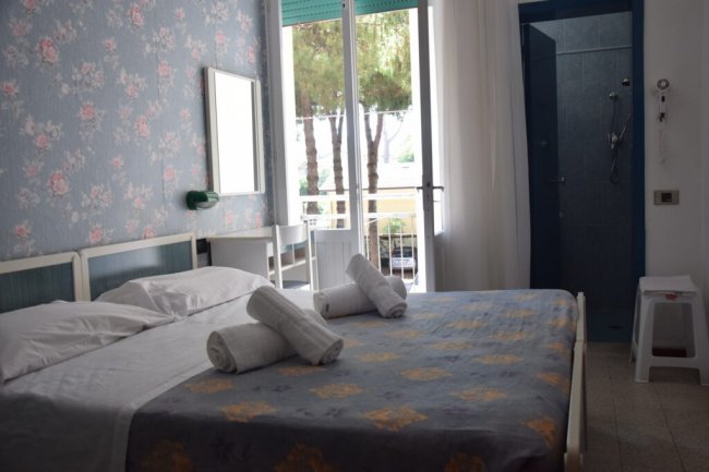 Camera da letto con balcone e bagno.