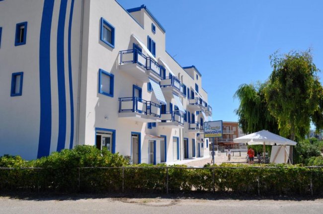 Edificio bianco e blu con balconi e insegna