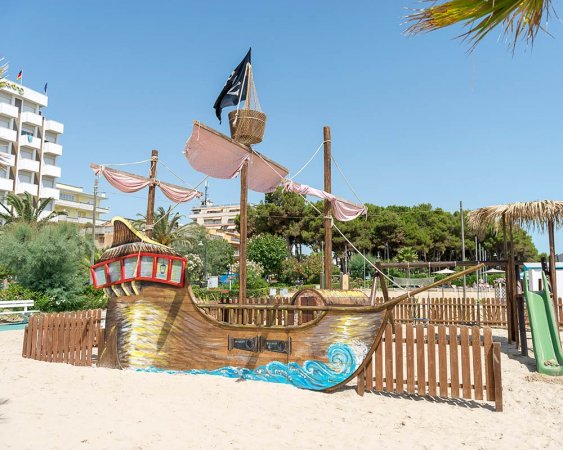 Area giochi con nave pirata in spiaggia.