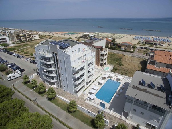 Complesso residenziale con piscina vicino alla spiaggia.