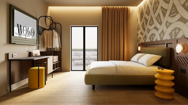 Camera d'albergo con letto, scrivania e decorazioni calde.