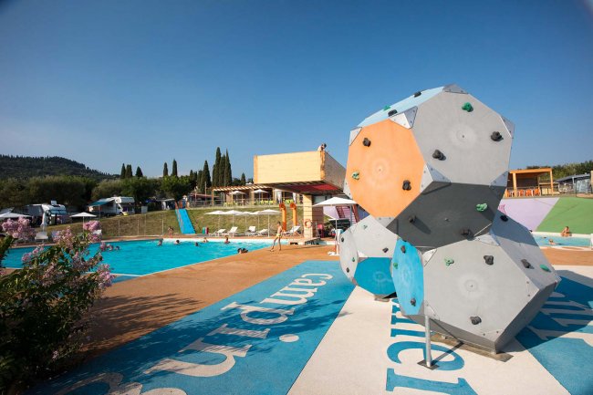 Piscina con struttura per arrampicata e area giochi.