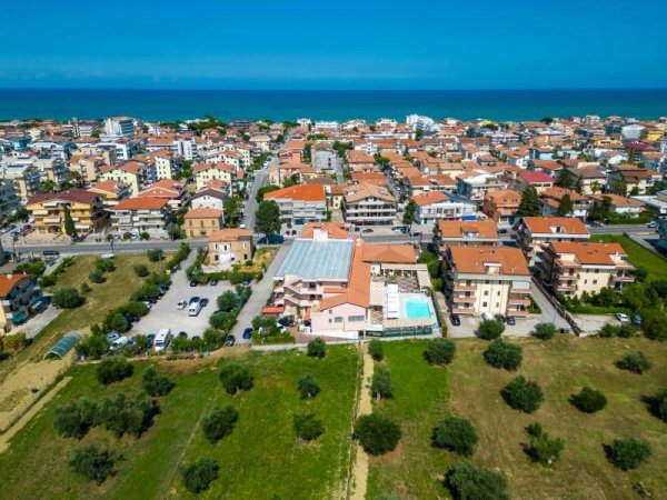 Vista aerea di una città costiera con case e mare.