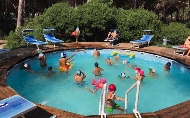 Bambini giocano in piscina rotonda.
