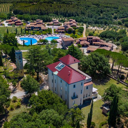 Struttura con tetto rosso vicino a piscine circondate da alberi.