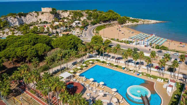 Vista su piscina e spiaggia sabbiosa.