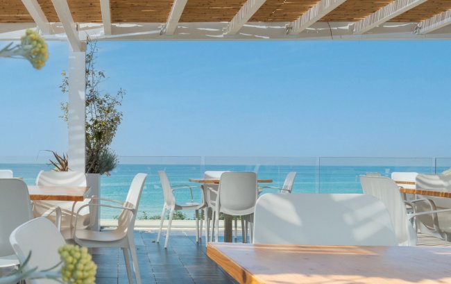 Ristorante all'aperto con vista sul mare.