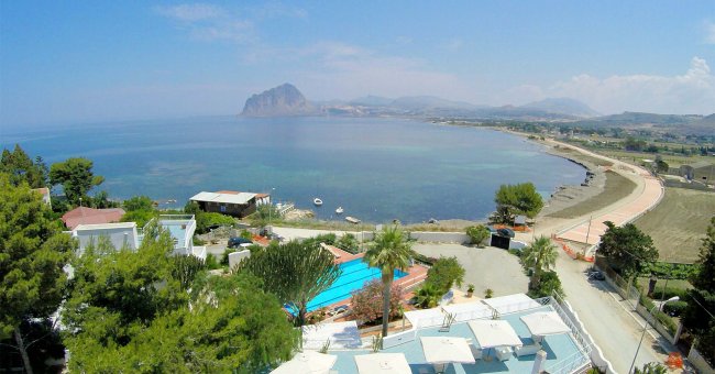 Vista panoramica sul mare con spiaggia e montagne.