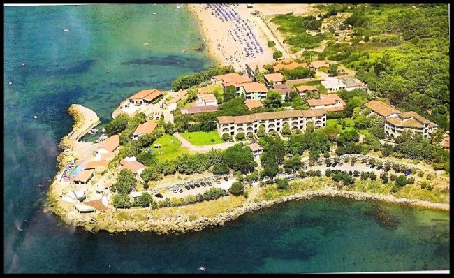 Vista aerea di un complesso residenziale costiero vicino a una spiaggia.
