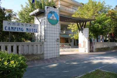 Ingresso di un camping motel con cartello e struttura moderna.
