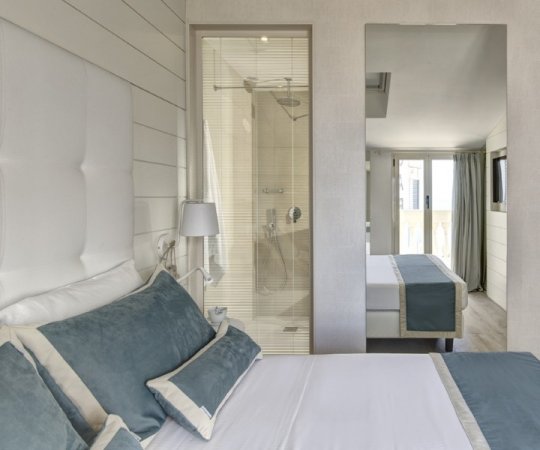 Camera d'hotel elegante con letto e doccia.