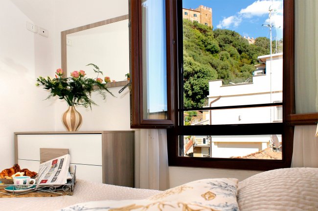 Camera con finestra aperta, vista esterna su colline.