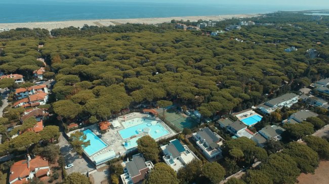 Vista aerea di un campeggio con piscine e alberi.