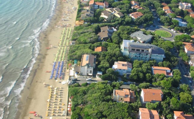 Spiaggia affollata con ombrelloni colorati.
