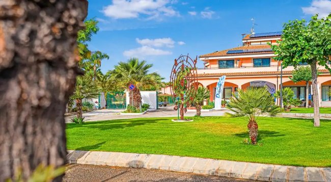 Edificio con giardino e sculture.